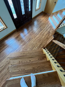 A wooden stairway in a home, featuring polished hardwood floors that enhance the interior's elegance and warmth.