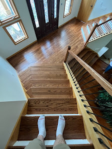 A wooden stairway in a home, featuring polished hardwood floors that enhance the interior's elegance and warmth.