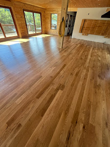 A wooden stairway in a home, featuring polished hardwood floors that enhance the interior's elegance and warmth.