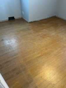 A spacious room with warm wood floors