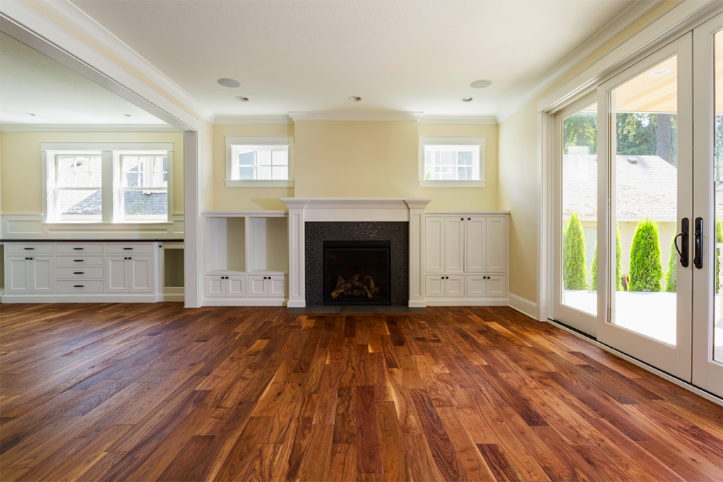 Beautiful wood flooring in a living room that does not have furniture in it
