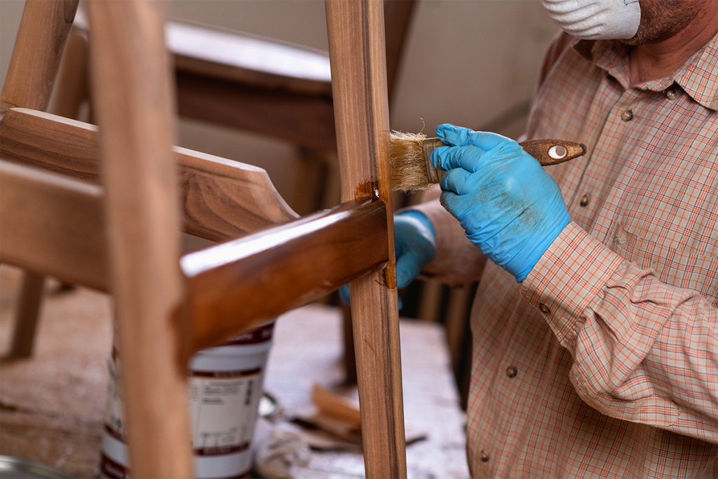 someone refinishing a piece of furniture